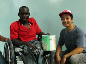 仮設校舎のペンキ塗りを手伝ってくれた障害者の男性と高橋駐在員（右）