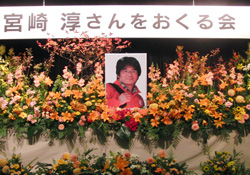 花に囲まれた宮崎さんの写真