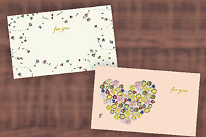 ピンクとクリーム色のメッセージカード。小さな花の絵があしらわれています"