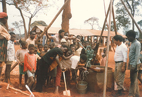 People gather around a well.