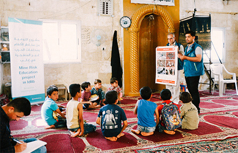 staff and children sitting around them taking the course