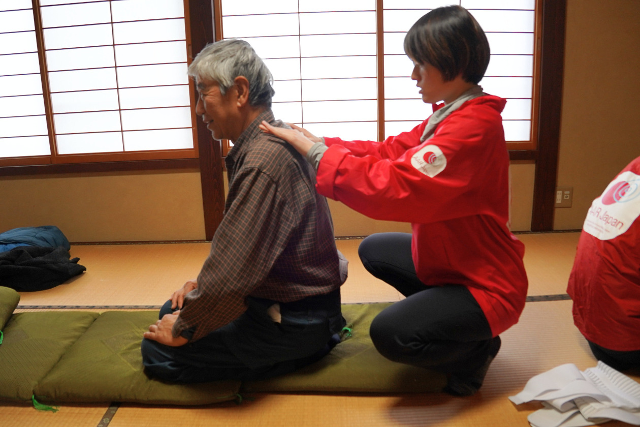A physical therapist massages a man