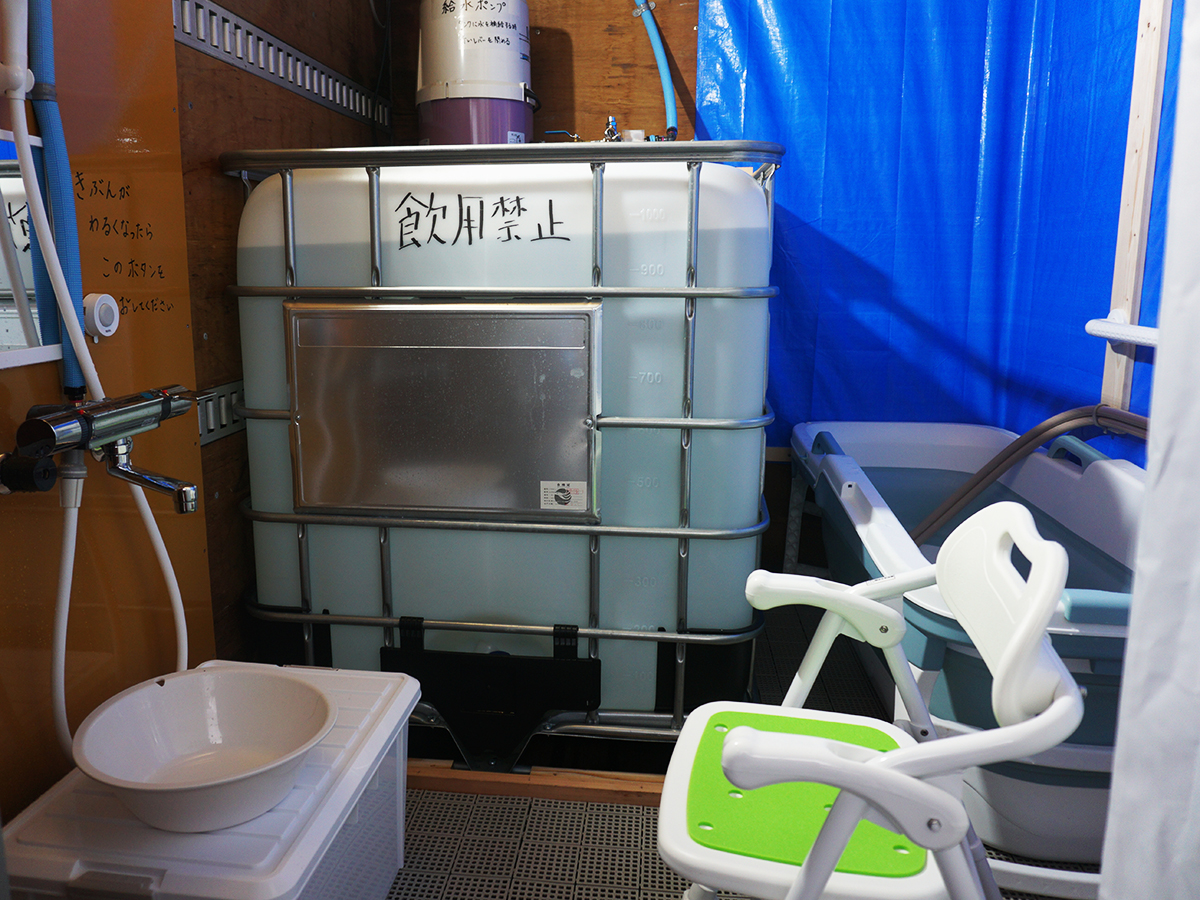 Inside the mobile hot bath truck, equipped with a chair and a wash basin