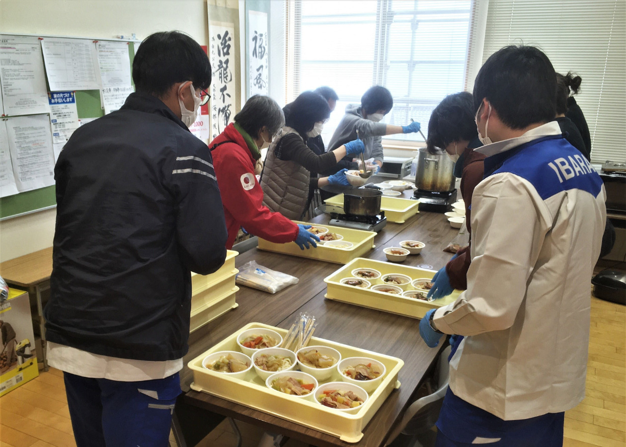 People serving udon noodles