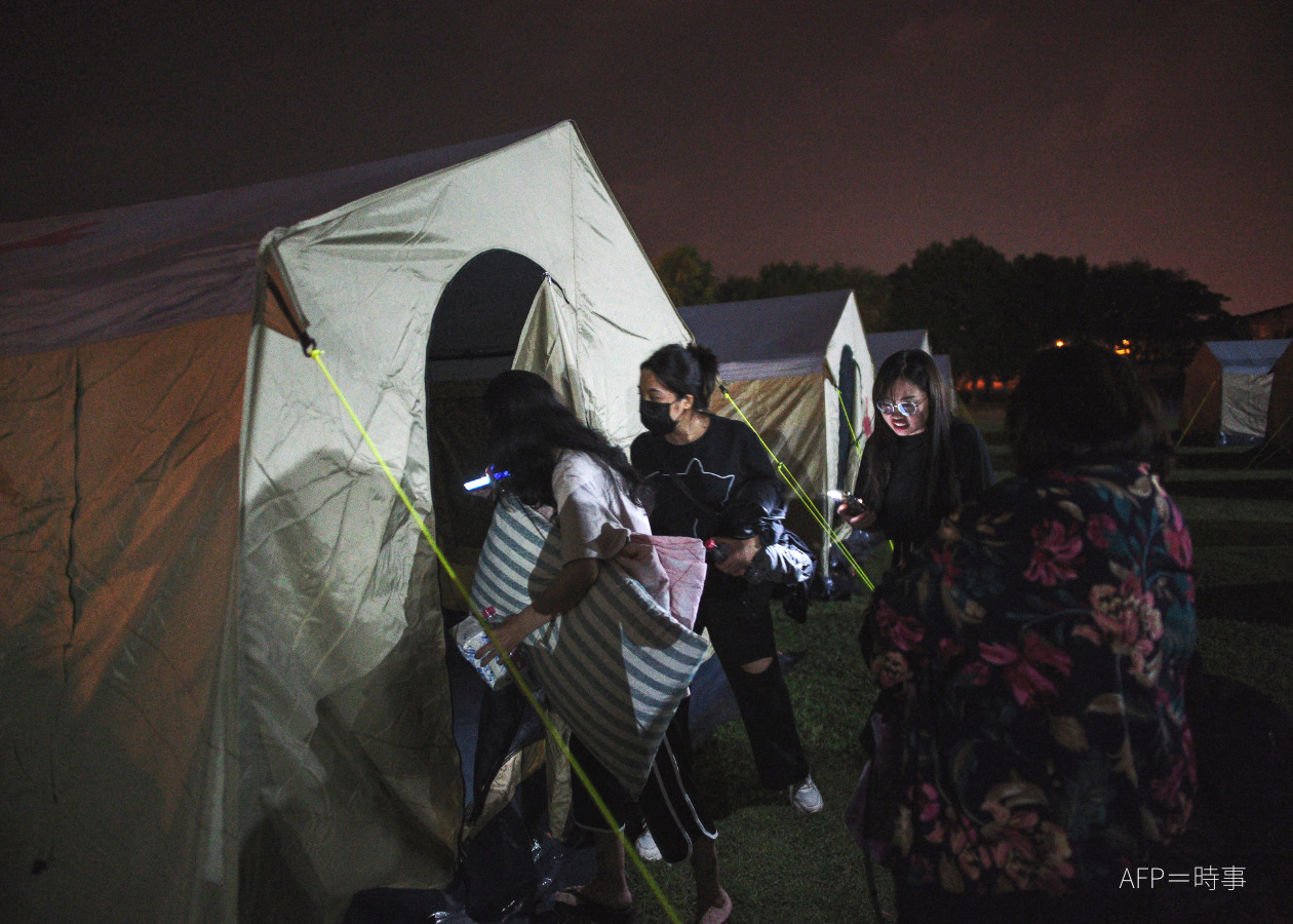 Survivors entering a temporary shelter
