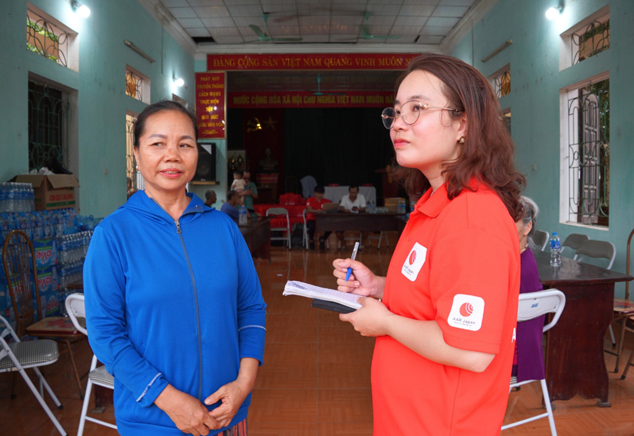 Two women are standing talking.