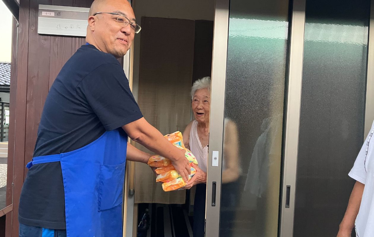 AAR staff handing out relief supplies at the entrance