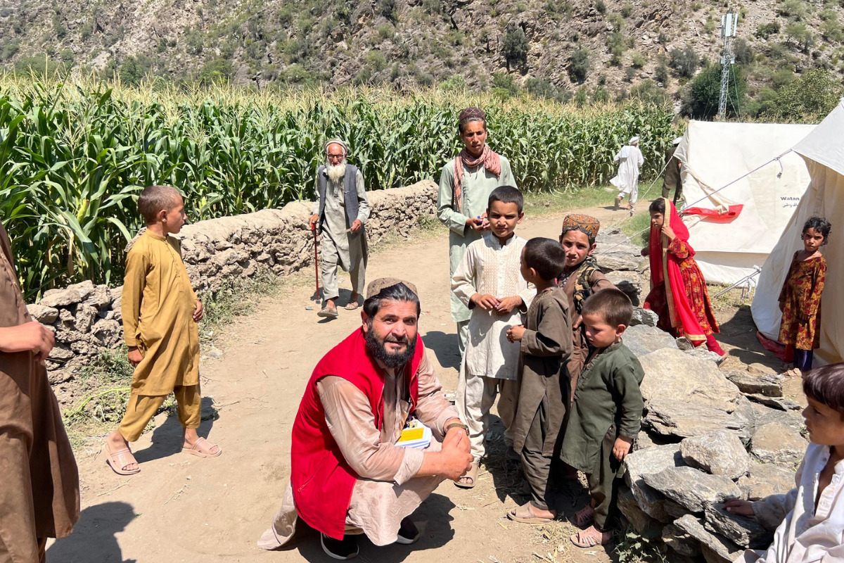 A man is talking to the children