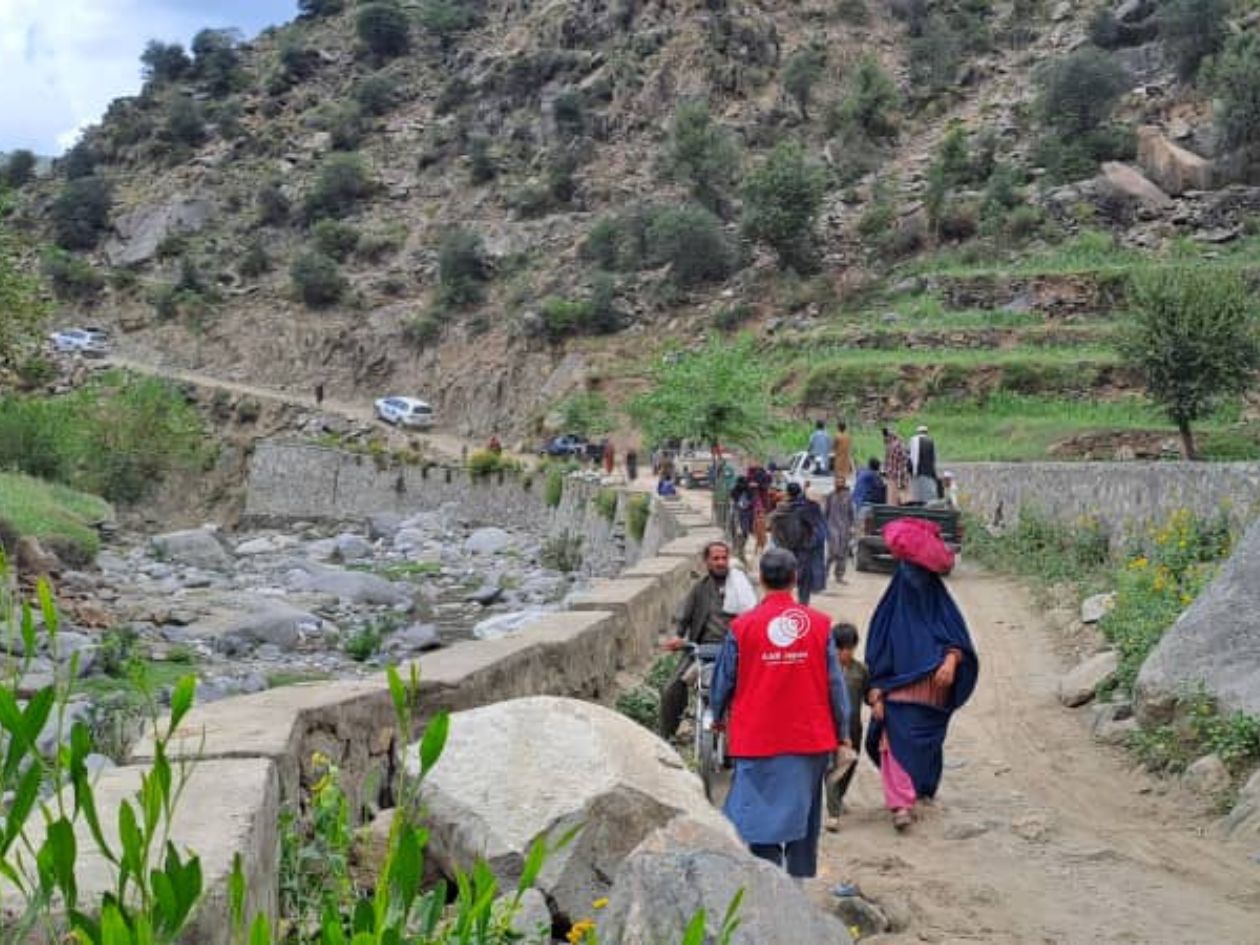 People are walking up the mountain road