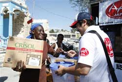 緊急支援物資を受け取り喜ぶハイチ地震の被災者