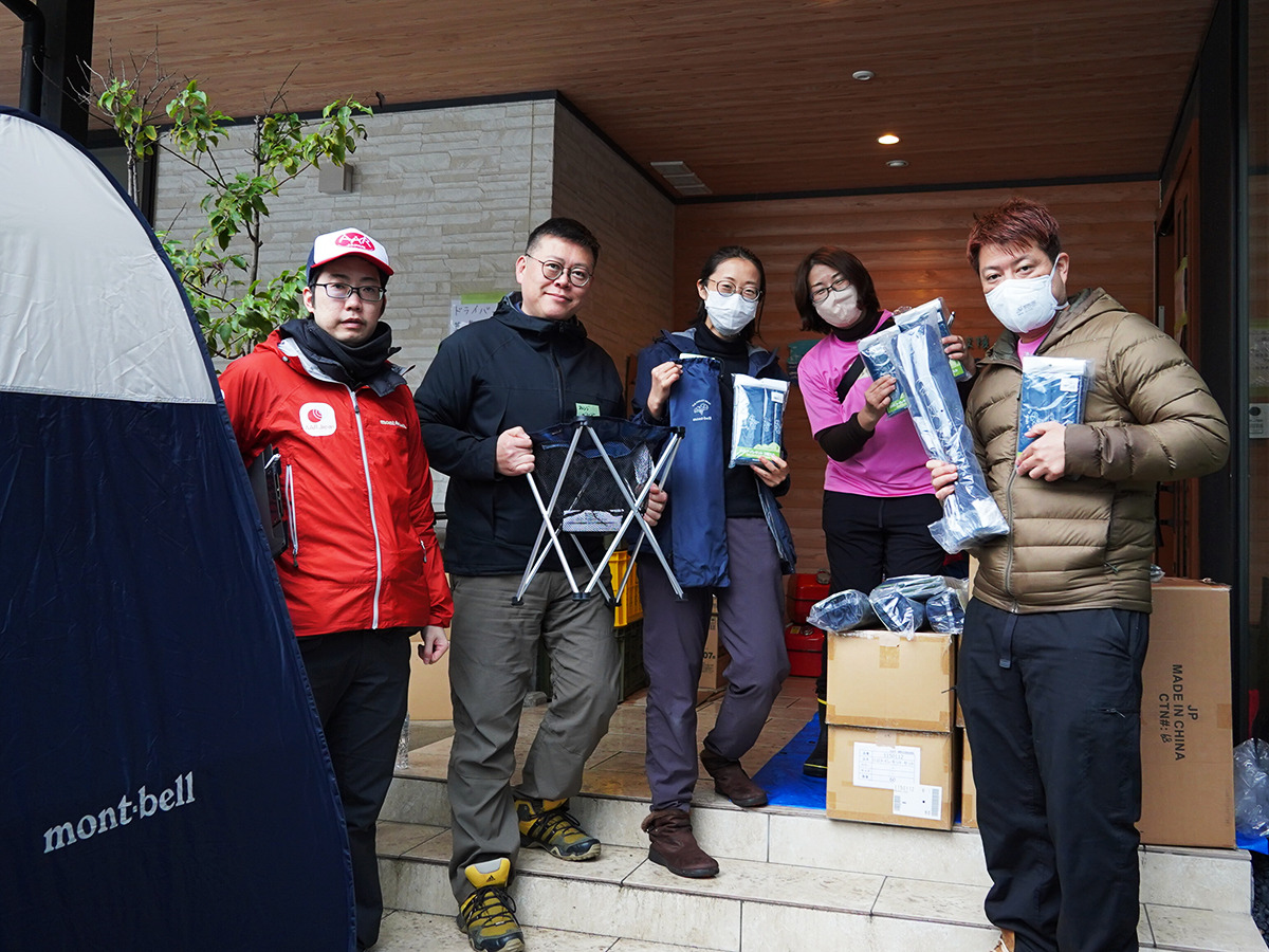 Five men and women standing with the supplies they received.