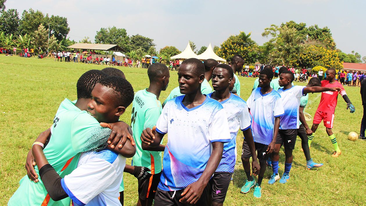 両チームのメンバーが並んでハグしたりあいさつしたりしている